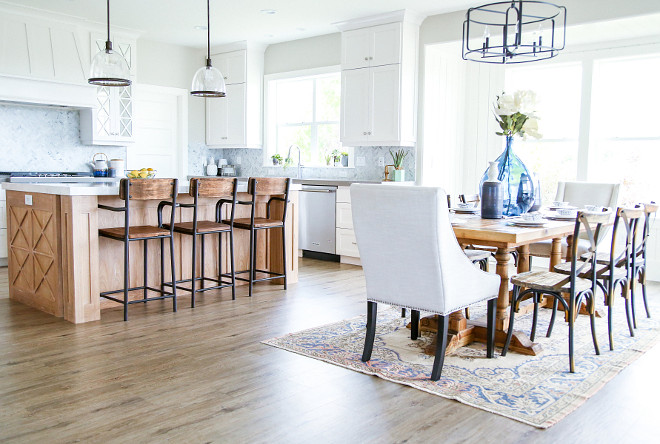 Open kitchen and dining room layout. Plenty of windows and doors bring lots of natural light to the entire main floor while neutral colors keep everything looking crisp. Millhaven Homes