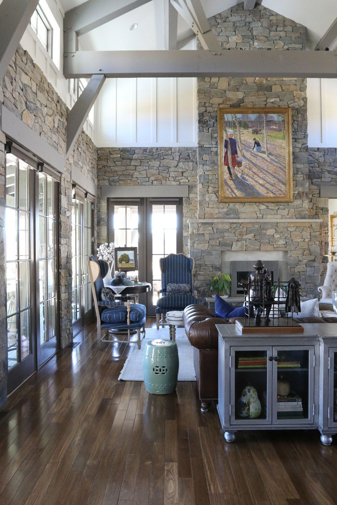 This gorgeous great room feature incredible natural stone walls and Brazilian Cherry hardwood floor. Wall paint color is Sherwin Williams SW 7012 creamy. Beams and trims are Sherwin Williams SW 0023 Pewter Tankard #livingroom #greatroom #paintcolor #stone #hardwood living-room-with-stone-fireplace-stone-walls-and-brazilian-cherry-hardwood-floors Home Bunch's Beautiful Homes of Instagram - @artfulhomestead