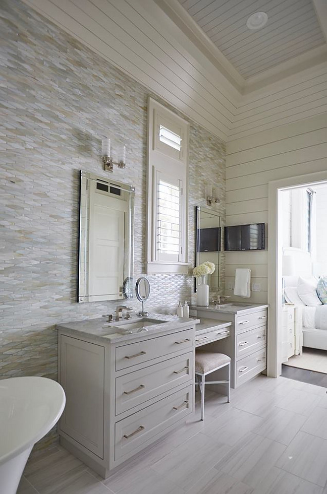 Oblong Marble Tile Wall. Bathroom features Oblong Marble Tile and shiplap walls. This master bathroom features an oblong marble tile accent wall, neutral floor tiles and light gray his and her washstands flanked by a drop down makeup vanity. Vanity paint color is similar to Benjamin Moore OC-52 Gray Owl. shiplap-bathroom-with-tile-accent-wall