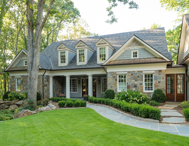 Home exterior. The exterior stone is Tennessee Grey Orchard. Exterior trim paint color is Benjamin Moore White Dove. Wood Door stain is Provential with 20% brown tint added.