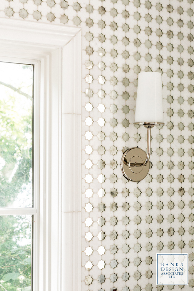 Kitchen Tile. The kitchen features counter-to-ceiling marble and mirror backsplash tiles that gently reflects the water outside. Tile: Arabesque tile from Distinctive Tile on Forest Ave. in Portland, ME. Lighting is RH Modern Taper Sconce with Glass Shade. #kitchetile #backsplash #tile #mirrortile #marbleandmirrortile Banks Design Associates, LTD & Simply Home