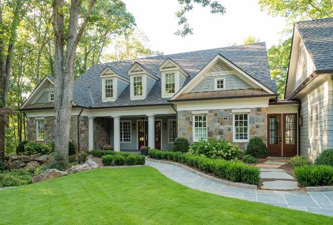 Traditional home ideas. This house is located in a well established neighborhood in Atlanta with mature trees and shrubs. The former house was a dark, dated ranch and this couple wanted an updated, bright home with open concept interiors with great entertaining spaces that centered around the pool and gardens. They also wanted the house to seem like it had always been there. The shingles and stone work are classic architectural features that stand the test of time. #traditionalhomes traditional-home-exterior Interiors by Courtney Dickey. Architecture by T.S. Adam Studio.