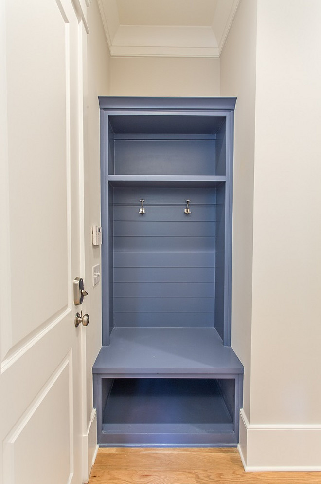 Blue Mudroom Cabinet. Small Blue Mudroom Cabinet. Space saving built-in blue mud room storage bench with tongue and groove paneling accented with nickel coat hooks below open cubby storage. #BlueMudroomCabinet #SmallBlueMudroomCabinet #BlueCabinet #mudroomcabinet #mudroom #cabinet #smallmudroom #smallinteriors #smallspaces