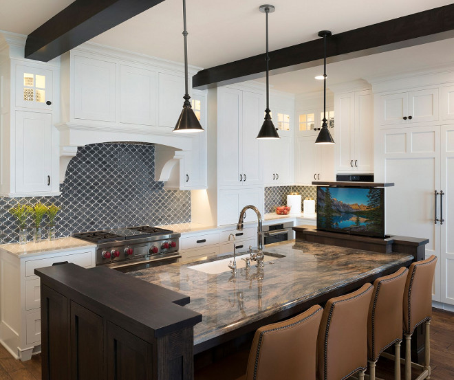 Kitchen TV. Kitchen tv ideas. Sophisticated technology throughout the home includes a lift mounted television in the kitchen. #kitchentv #kitchen #tv Stonewood LLC. Studio M Interiors. Spacecrafting Photography.