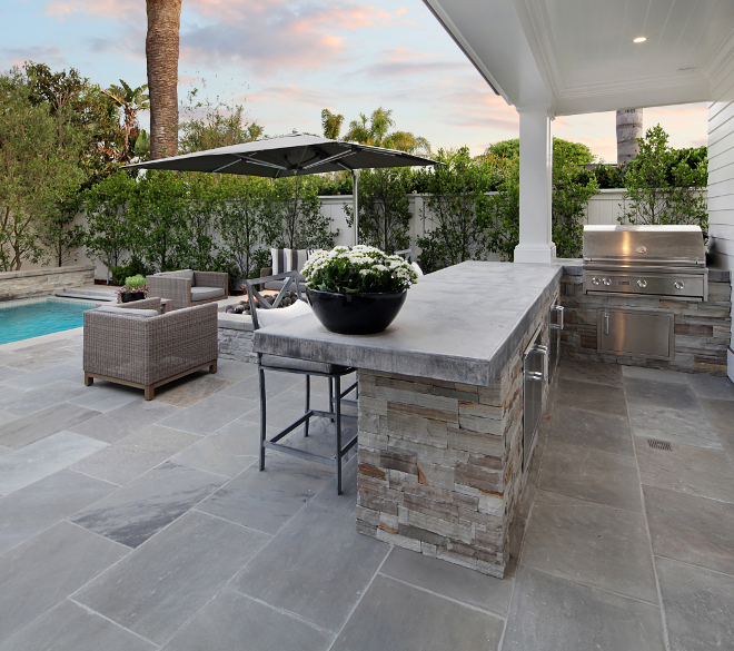 Outdoor Kitchen. The outdoor kitchen features concrete countertop and stone. These pavers are a natural stone called Shadow Gray. Outdoor Kitchen Outdoor Kitchen Ideas. Outdoor Kitchen Layout #OutdoorKitchen Brandon Architects, Inc