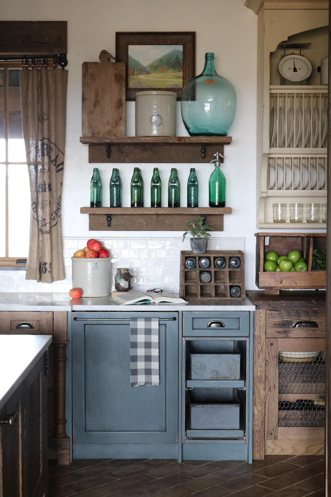 Rustic Kitchen Cabinet Combination. Rustic Farmhouse kitchen features rustic oak cabinets and blue gray cabinets. The blue cabinetry in kitchen was first stained, painted white, then custom blue, and then distressed. Similar paint color is Benjamin Moore West Coast distressed and glazed. Kitchen Cabinet Combination. #RusticKitchen #CabinetCombination #oakcabinets #rusticoakcabinets #distressedcabinet #rustickitchencabinet #BenjaminMooreWestCoast #glazedcabinets #distressed Home Bunch's Beautiful Homes of Instagram @birdie_farm