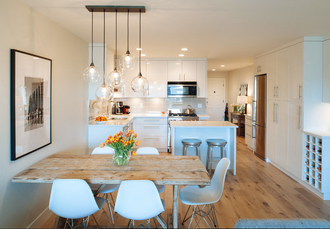 Apartment Lighting. Open feel apartment with modern lighting. The light fixture is a Firefly pendant light from CB2 Lighting. #ApartmentLighting #apartment #lighting Kenorah Design + Build Ltd