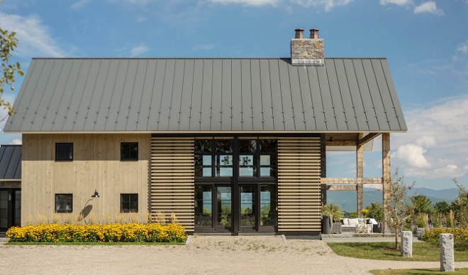 Barn Style Farmhouse. The farmhouse feature wood slat barn doors. Barn Style Farmhouse Exterior. Barn Style Farmhouse Architecture. Barn Style Farmhouse Design #BarnStyleFarmhouse #Barn #Farmhouse #Exterior #BarnFarmhouseArchitecture #FarmhouseDesign #BarnFarmhouses Roundtree Construction. TruexCullins Architecture + Interior Design