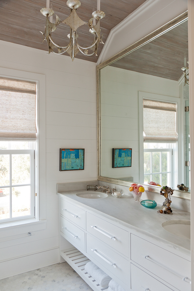 Bathroom with white shiplap walls and washed shiplap ceiling. Master Bathroom with white shiplap walls, washed shiplap ceiling and lucite cabinet pulls. The painted wood vanity features open shelf and Alabama White Marble top. #bathroom #whiteshiplapwalls #whiteshiplap #shiplapwalls #washedshiplapceiling #washedshiplap #shiplapceiling #shiplap Beau Clowney Architects. Jenny Keenan Design