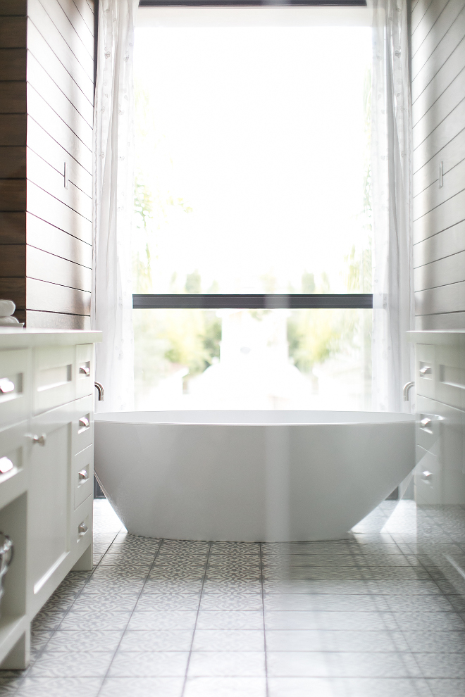 Bathroom. Master bathroom with stained shiplap walls and cement tile. The sleek really pops set against the master bathroom's t&g wood stained accent wall and handmade, custom white and grey concrete tile floor. Tub is manufactured by Victoria & Alberto. #Bathroom. #Masterbathroom #stainedshiplap #stainedshiplapwalls #cementtile Patterson Custom Homes