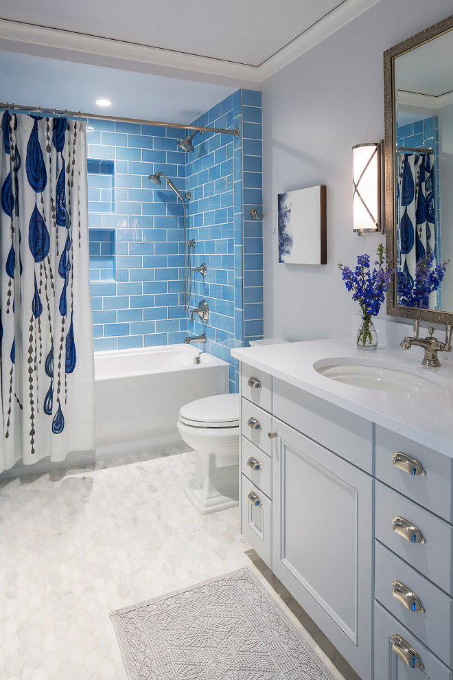 Blue subway tile. Bathroom with blue subway tile wall and hex marble floor tile. Blue subway tile #Bluesubwaytile Martha O'Hara Interiors