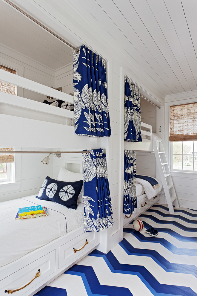 Bunk Bed Drapery. Bunk room features custom bunk beds with rod and draperies on each bunk bed for privacy. The bunk room features custom curtained bunk beds and rope bed handles. The floor is painted in a blue and white chevron pattern. #BunBeds #Draperies #Bunkroom #CoastalBunkroom #custombunkroom #custombunkbeds Beau Clowney Architects. Jenny Keenan Design
