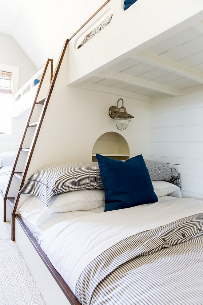 Bunk beds with nautical lighting and built in bookcase. White Bunk beds with alder trim, nautical lighting and built in bookcase #WhiteBunkbeds #Bunkbeds #aldertrim #nauticallighting #builtinbookcase Timberidge Custom Homes