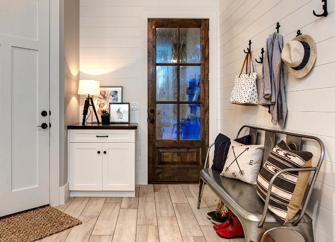 Farmhouse Mudroom. Modern Farmhouse mudroom with shiplap walls and glass door. #FarmhouseMudroom #FarmhouseMudroomIdeas #FarmhouseMudroomDesign #Farmhouse #Mudroom #ModernFarmhouse #ModernFarmhouse #ModernFarmhousemudroom #mudroom #shiplap #glassdoor Timberidge Custom Homes