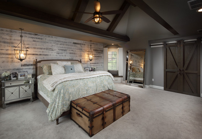 Farmhouse bedroom with vaulted ceiling, barn doors and whitewashed shiplap accent wall. #Farmhousebedroom #vaultedceiling #barndoors #whitewashedshiplap #shiplap #accentwall Barrington Homes Inc.