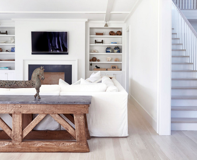 Hamptons style living room with bleached wood floors, white walls, white slipcovered sofa and reclaimed wood and zinc top console table. #Hamptonsstyle ##Hamptonsstylelivingroom #livingroom #Hamptonsstyleinteriors #bleachedwoodfloors #bleachedhardwood #whitewalls #whiteslipcoveredsofa #slipcoveredsofa #reclaimedwoodandzinctoptable #consoletable Chango & Co.