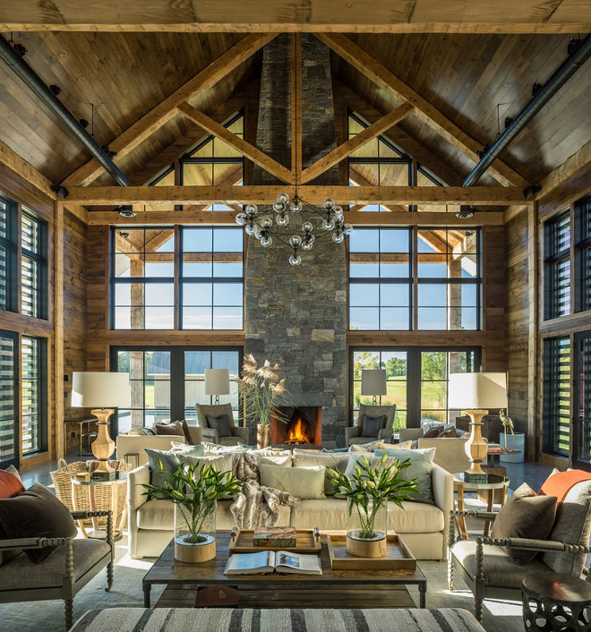 Rustic Barn. Rustic Barn Interiors. Rustic Barn with reclaimed wood, vaulted wood ceiling, exposed beams, reclaimed wood paneling and black pane windows and black pane sliding doors. Roundtree Construction. TruexCullins Architecture + Interior Design #blackpaneglassslidingdoors #glassslidingdoors #barn #rusticbarn #rusticinteriors #blackpanewindows #rusticwood #beams