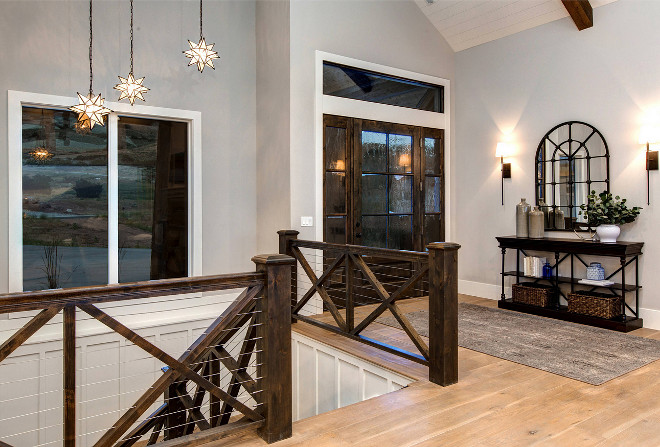 Staircase with Crossed wood balusters and cable railing. Farmhouse Staircase with Crossed wood balusters and cable railing. Made of Alder, the staircase brings a modern farmhouse feel to this home. #Farmhousestaircase #Staircase #Crossedwoodbalusters #Crossedwoodbalusters #cablerailing Timberidge Custom Homes