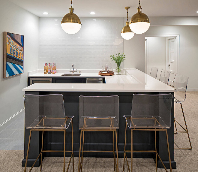 Basement Bar painted in navy paint color Benjamin Moore HC-154 Hale Navy, White subway tile, Hicks Pendants, white quartz countertop and Gabby Home Acrylic Bar Stools. 