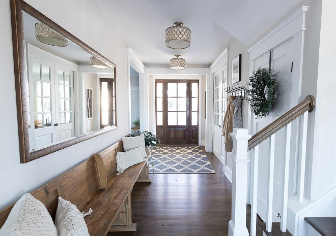 Foyer Bench. Light grey foyer with long wood bench, Walnut stained hardwood floors and Walnut front door #Foyer #Bench #Foyerbench #Lightgreyfoyer #longbench #Walnutstainedhardwoodfloors #walnuthardwoodfloors #Walnutfrontdoor Beautiful Homes of Instagram @greensprucedesigns