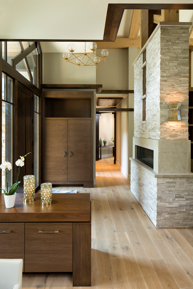 Foyer with fireplace and custom cabinetry for storage, Lighting is Rowan G Chandelier from Worlds Away, Chandelier features gold leaf finish and hand blown glass globes #Foyer #Foyerfireplace #foyercabinetry #foyerstorage Hendel Homes