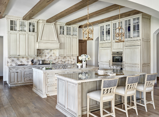 French Kitchen. Off-white French Kitchen Design. French Kitchen with glazed off-white cabinets. Off-white French Kitchen Color. This French kitchen features white oak hardwood floors, two islands, ceiling beams and glazed off-white cabinets. #OffwhiteFrenchKitchen #OffwhiteFrenchKitchenDesign #GlazedCabinets #Glazedkitchencabinet Kim Scodro Interiors