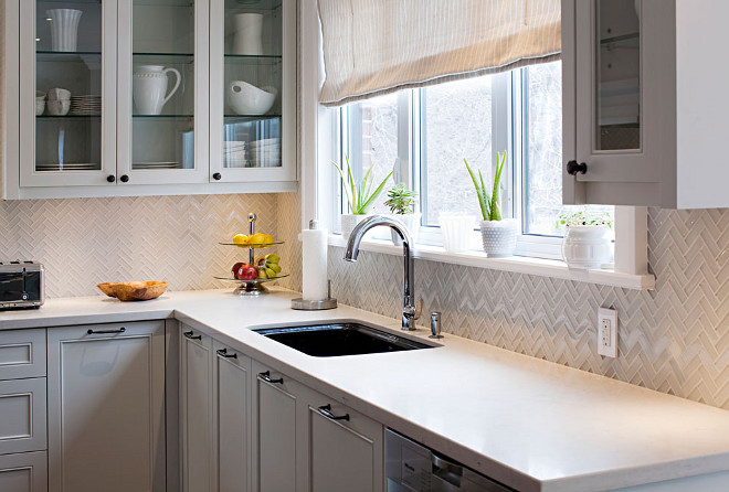 Herringbone backsplash. Herringbone tile backsplash. The herringbone tile backsplash is 3x1 herringbone backsplash in polish and hone glass. Countertop is Ceasarstone London Grey. #herringbone #backsplash #tile #CeasarstoneLondonGrey Hardcore Renos.