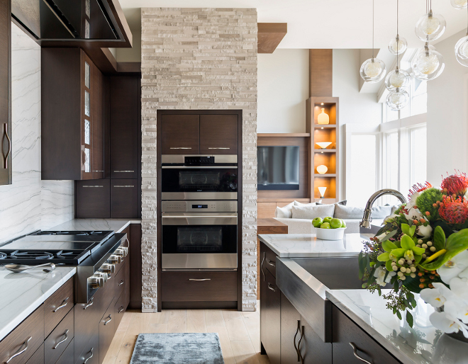 Kitchen Wall Oven, Wall Oven,The wall oven features stone and walnut cabinetry, Kitchen Wall Oven Ideas #KitchenWallOven #WallOven Hendel Homes