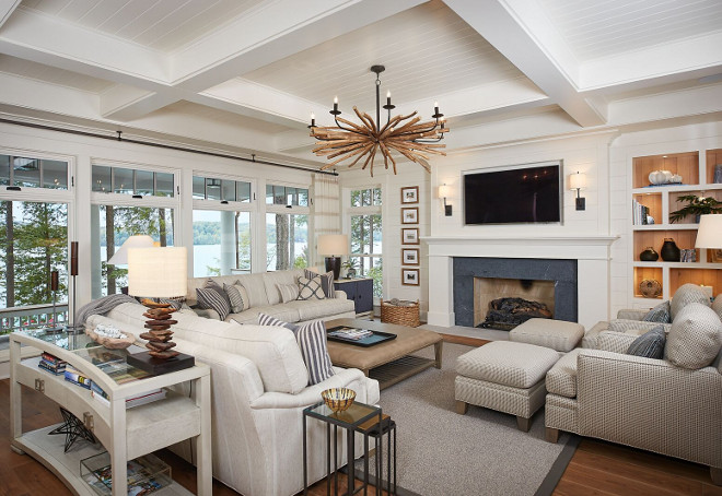Lakehouse living room with shiplap walls, shiplap fireplace, coffered ceiling and many windows to let the lake view in #lakehouse #livingroom #shiplap Dwellings