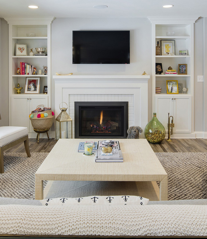 Living room bookcase built ins and painted brick fireplace. The built-ins and the fireplace brick are painted in Sherwin Williams Alabaster. Living room bookcase built ins and painted brick fireplace layout. Living room bookcase built ins and painted brick fireplace ideas #Livingroom #bookcase #builtins #paintedbrick #paintedbrickfireplace Revision LLC