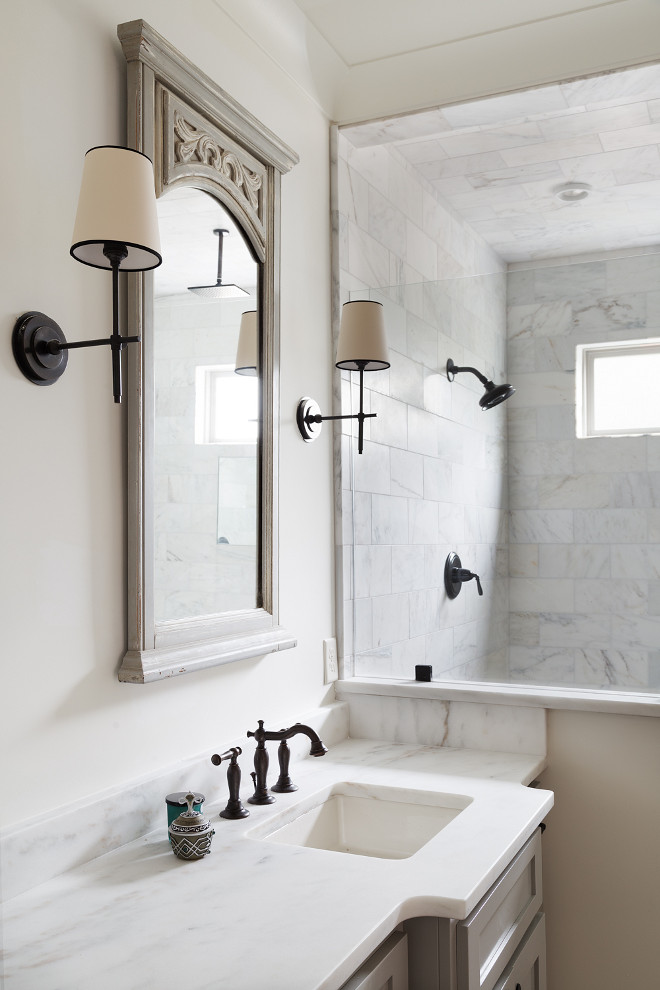 Bathroom. Bathroom with neutral paint color, white marble countertop, marble shower tile and French grey mirror #bathroom Willow Homes