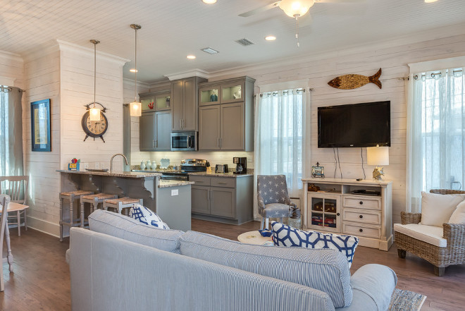 Beach Cottage with coastal decor, whiteashed shiplap walls, beadboard ceiling, wide plank hardwood floors and grey kitchen. #BeachCottage #coastaldecor #whiteashedshiplap #shiplap #beadboard #beadboardceiling #wideplank #hardwoodfloors #greykitchen Erin E. Kaiser, Kaiser Real Estate Sales, Inc