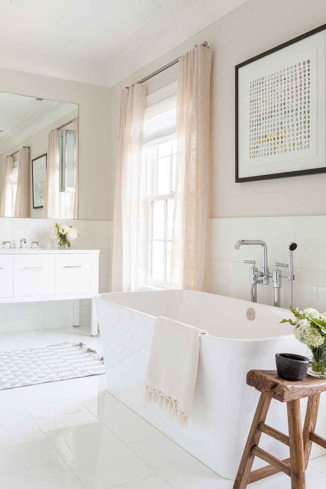 Beige bathroom with natural linen draperies and white thassos marble floor tile, Bath filler is by Waterworks #BeigeBathroom #sheerdraperies #thassos #marble #floortile Chango & Co