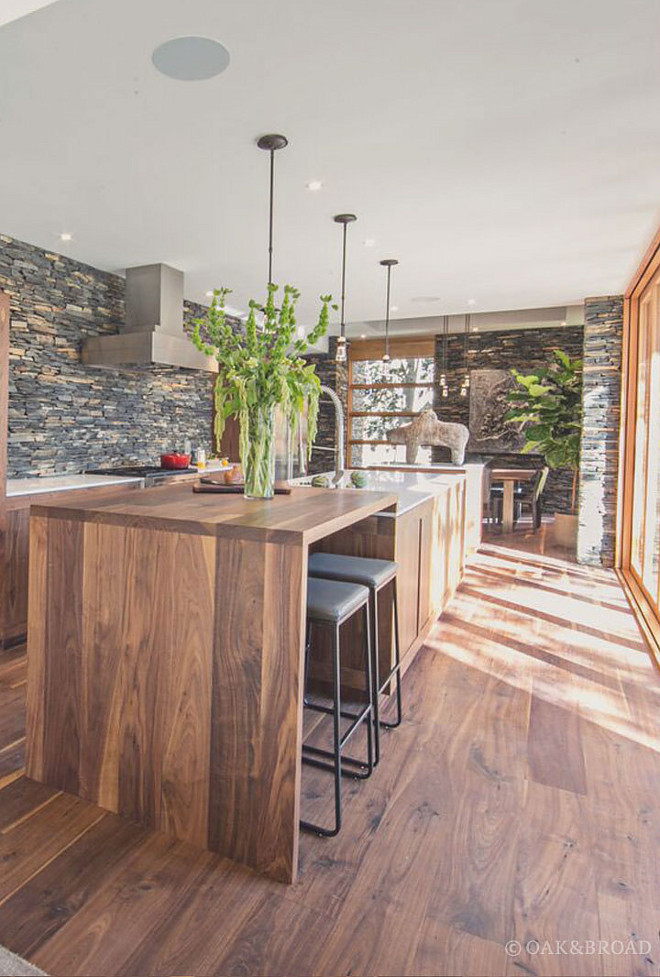 Black Walnut Wide Plank Floor and Vlack Walnut Island to match the hardwood floors- While most wide plank floors are made from White Oak, Black Walnut makes a unique, stunning statement that will never go out of style. Of course, you can stain Black Walnut just like any wood, but we think it looks best with a simple oil finish that shows off its natural character Oak & Broad