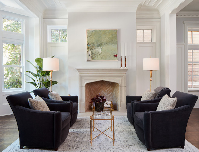 Classic White living room with herringbone fire brick and limestone surround fireplace. #ClassicWhitelivingroom #Classiclivingroom #livingroom#herringbonefirebrick #limestonefireplace Middlefork Development LLC