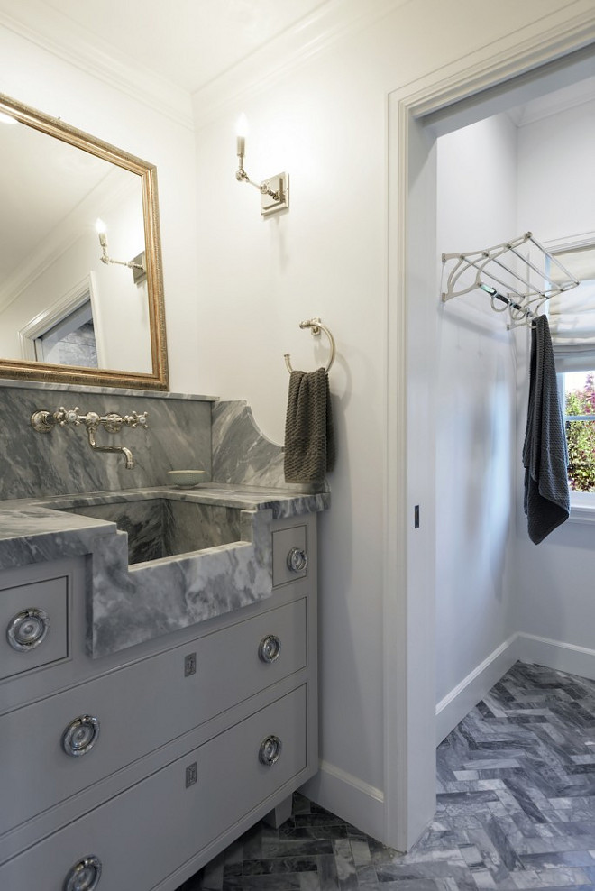 Custom grey bathroom vanity with grey marble countertop and grey marble herringbone floor tile #Customgreybathroomvanity #greybathroomvanity #greyvanity #greymarble #countertop #greymarble #herringbonefloortile Hamilton Architects