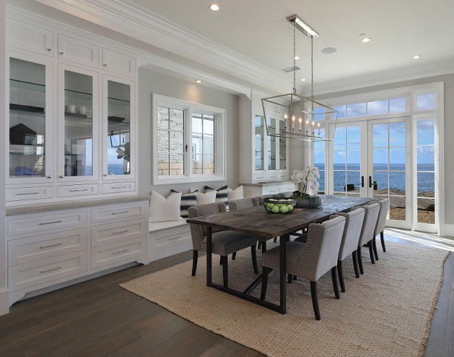 Dining room with builtin hutch cabinet, built in window seat and French doors to a backyard with ocean view #diningroom #builtinhutch #hutch #windowseat Brandon Architects, Inc