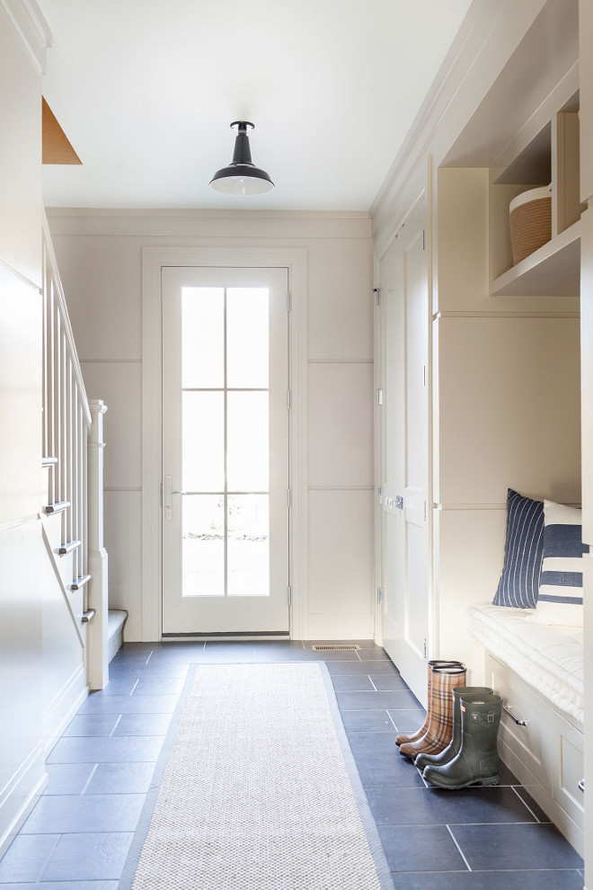 Farmhouse Mudroom, Neutral farmhouse mudroom with slate floor tile, jute runner, barn-style light and paneled walls painted in a mushroom-hued color, Neutral Farmhouse Mudroom #FarmhouseMudroom #Mudroom #Farmhouse #NeutralMudroom Chango & Co