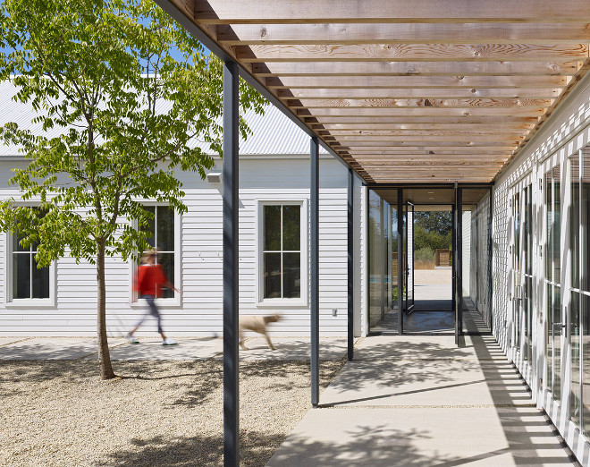 Farmhouse entry. The entry of this modern farmhouse features a shade structure made of open cedar trellis and steel posts #farmhouse #entry #trellis #farmhousedesign Nick Noyes Architecture