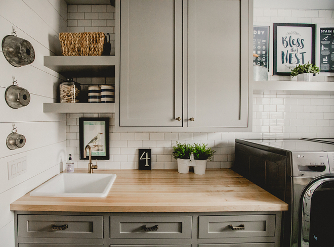 Farmhouse laundry room with grey cabinets, shiplap walls, white subway tile and Ikea butcher's block countertop. Cabinets are custom built maple, shaker style. Farmhouse laundry room #farmhouselaundryroom #farmhouse #laundryroom Beautiful Homes of Instagram @house.becomes.home