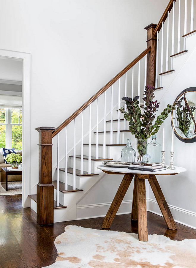 Foyer Table. Farmhouse inspired foyer with light gray walls, stained oak hardwood floors and trestle table. Table is Roost Sandblasted Marble Table #trestletable #foyertable #farmhousefoyer #farmhouse Kennerknecht Design Group