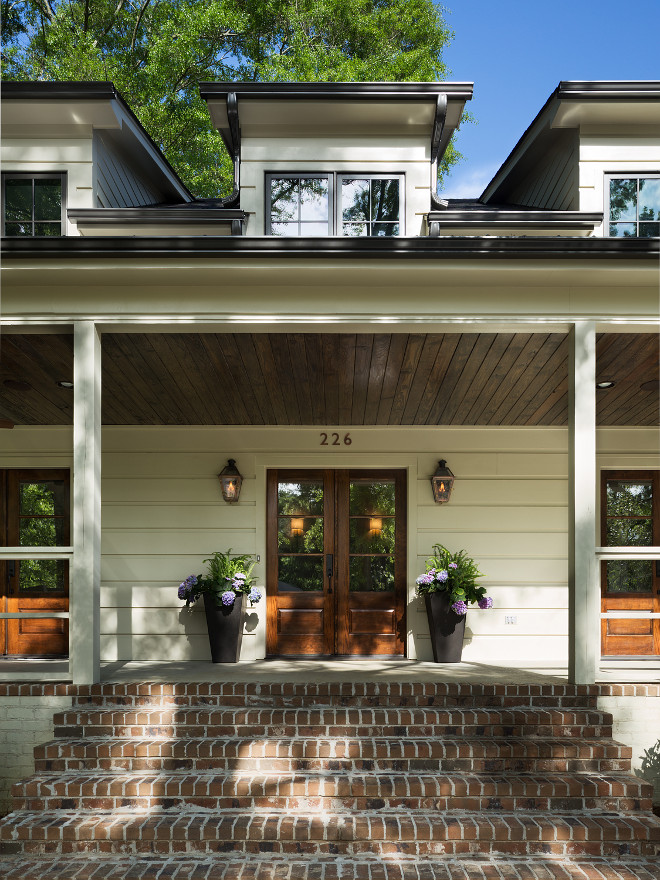 Front Door Planters and Porch with brick porch. Fir wood doors. The ceiling stain color is Provincial by Minwax. The windows are a Quaker brand aluminum clad and the doors are Fir wood doors. Porch with wood front door, planters and brick steps and brick porch. Front Door Planters and Porch with brick porch #FrontDoor #Planters #Porch #brickporch #brick Willow Homes