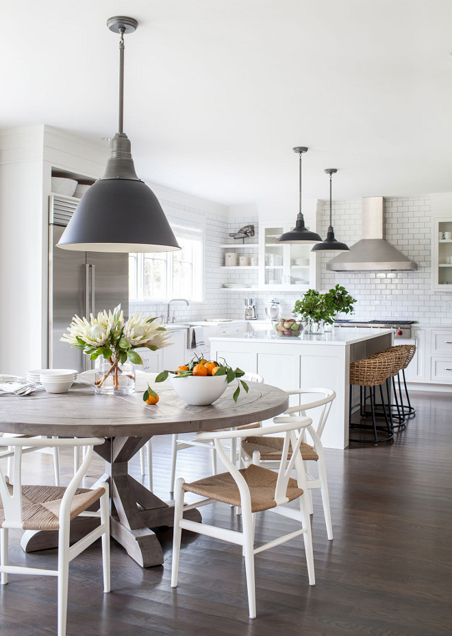 Modern Farmhouse Kitchen Design, Open Modern Farmhouse kitchen with kitchen nook, The kitchen nook features a round salvaged-wood dining table from RH, and Wishbone chairs by Hans J. Wegner from Design Within Reach Chango & Co #kitchennook #modernfarmhouse #kitchen #nook #roundtable #wishbone #wishbonechair #lighting