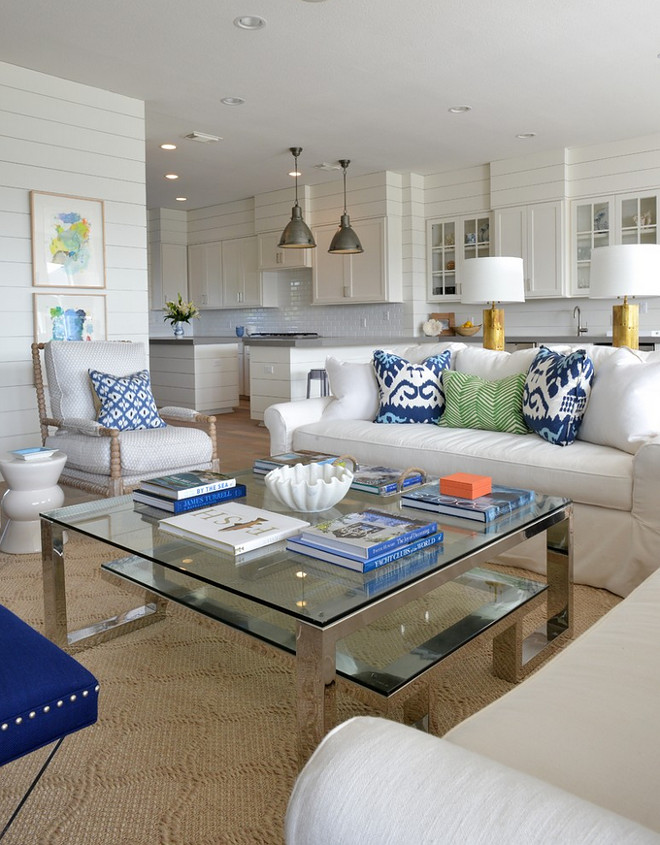 Open living room with shiplap paneled walls. Shiplap paneling surrounds this open coastal home. Open living room with shiplap paneled wall ideas. Open living room with shiplap paneled walls #Openlivingroom #shiplap #Shiplappaneling #paneledwalls