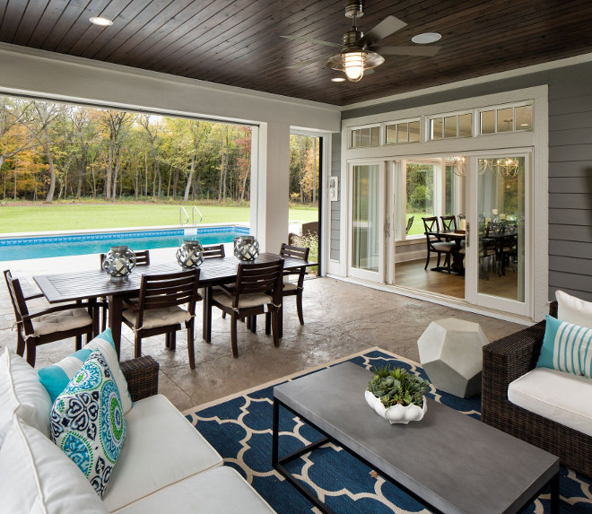 The backyard has a pool and a screened in porch with Phantom Screens to open to the backyard #screenedinporch #phatomscreens #backyard Grace Hill Design