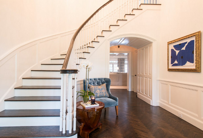 Traditional Foyer with herringbone hardwood floor. Traditional Foyer with curved staircase and herringbone hardwood floor #curvedstaircase #foyer #traditionalfoyer #herringbonefloor #hardwoodfloor #herringbonehardwoodfloor Munger Interiors