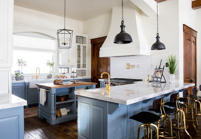 Two toned farmhouse kitchen. According to the designer, the inspiration for this project was a modern farmhouse with rustic and industrial elements. They wanted the kitchen to feel clean and crisp. To keep the kitchen bright, they went with white subway tile backsplash, beautiful Calacatta marble counters with a mitered edge and two-toned cabinets. Two toned farmhouse kitchen. Two toned farmhouse kitchen design. Two toned farmhouse kitchen #Twotonedfarmhousekitchen #Twotonedkitchen Becki Owens Becki Owens & Jamie Bellessa Heber