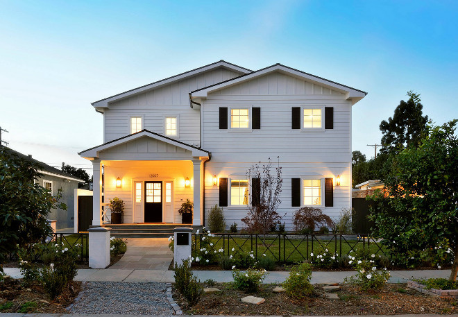 Modern white cape-cod home exterior with black shutters and black front door Hamilton Architects