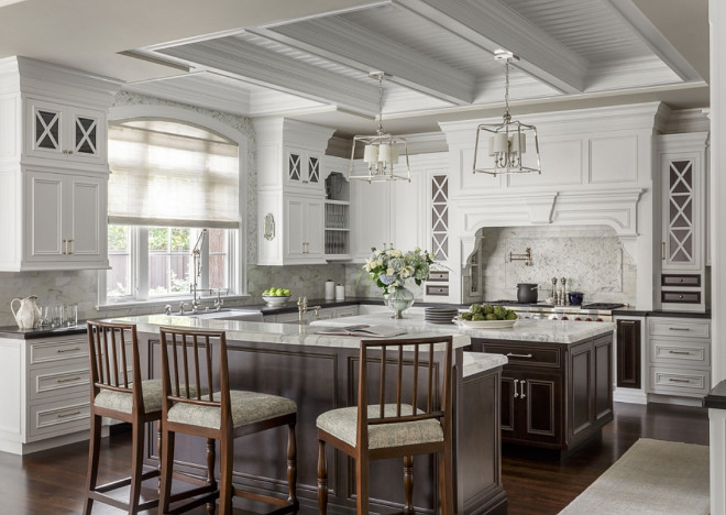 White kitchen with dark stained kitchen island, Stunning white kitchen with walnut stained kitchen islands, Classic White kitchen with dark stained kitchen island, White kitchen with dark stained kitchen island, White kitchen with dark stained kitchen island #Whitekitchen #classicwhitekitchen #kitchen #whitekitchens #timelesswhitekitchen #dark stainedkitchenisland Spectrum Interior Design, Inc