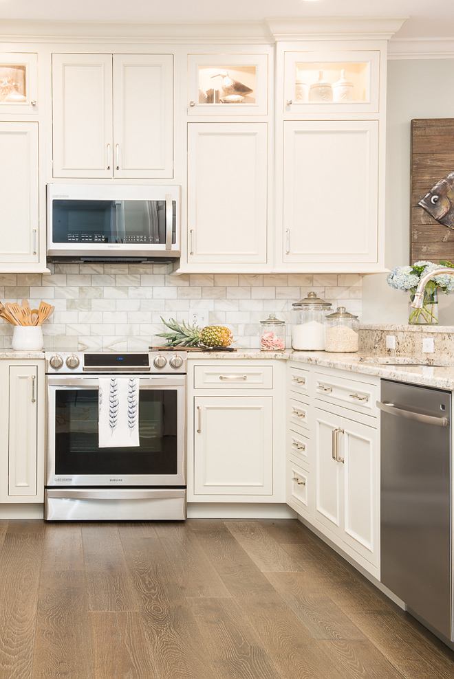 Beachy white kitchen with stacked white cabinetry, and marble backsplash. Beachy white kitchen with stacked white cabinetry, and marble backsplash Ideas. Beachy white kitchen with stacked white cabinetry, and marble backsplash #Beachywhitekitchen #whitekitchen #stackedwhitecabinetry #kitchenstackedcabinet #marblebacksplash Karr Bick